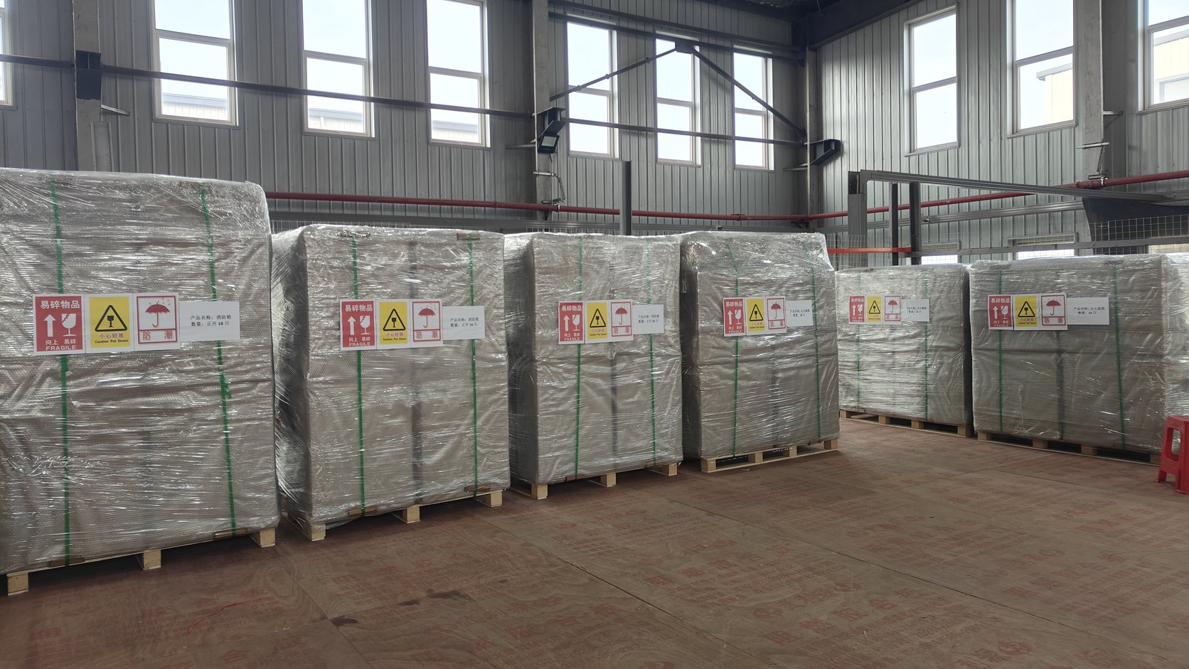 Palletised and stretch-wrapped fire hose boxes ready for export to India